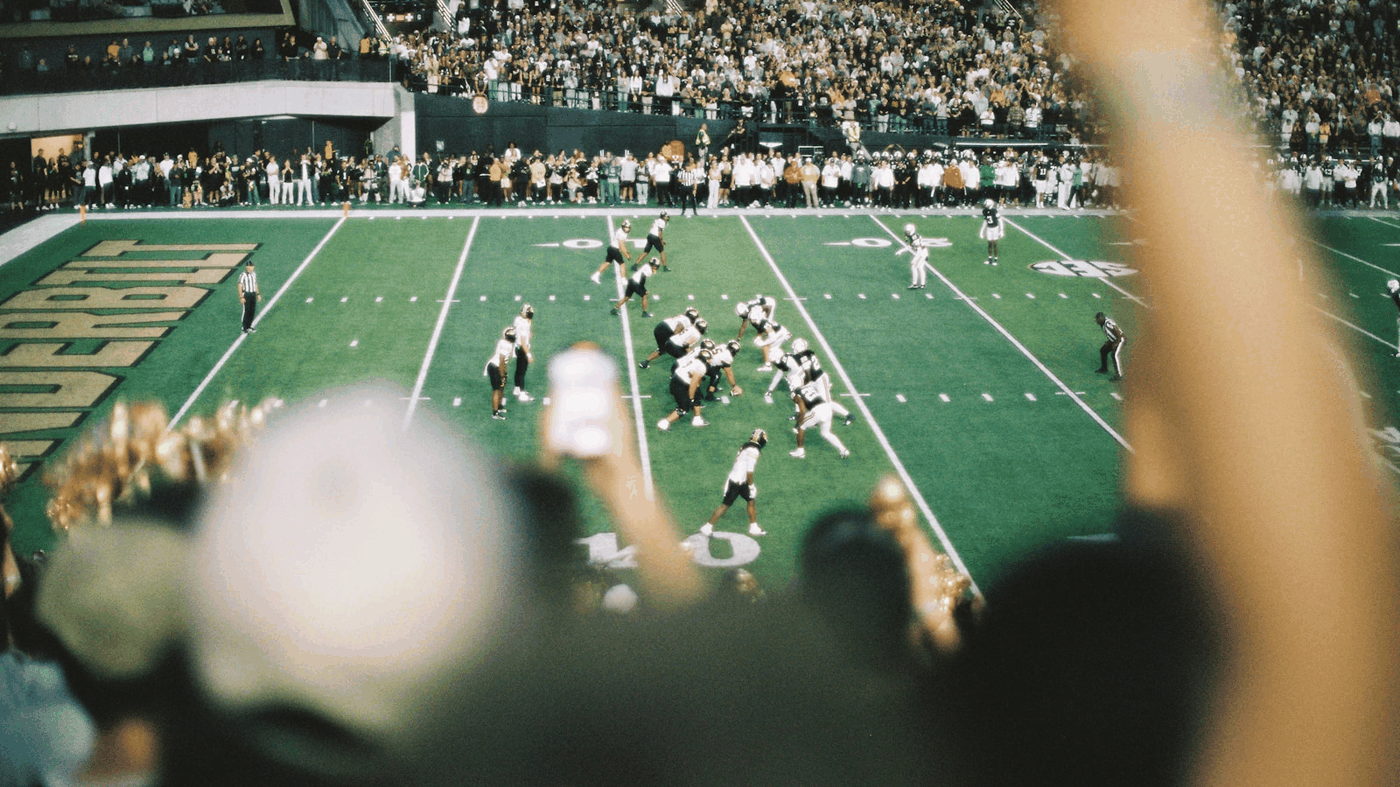 Fans cheering inside an NFL stadium